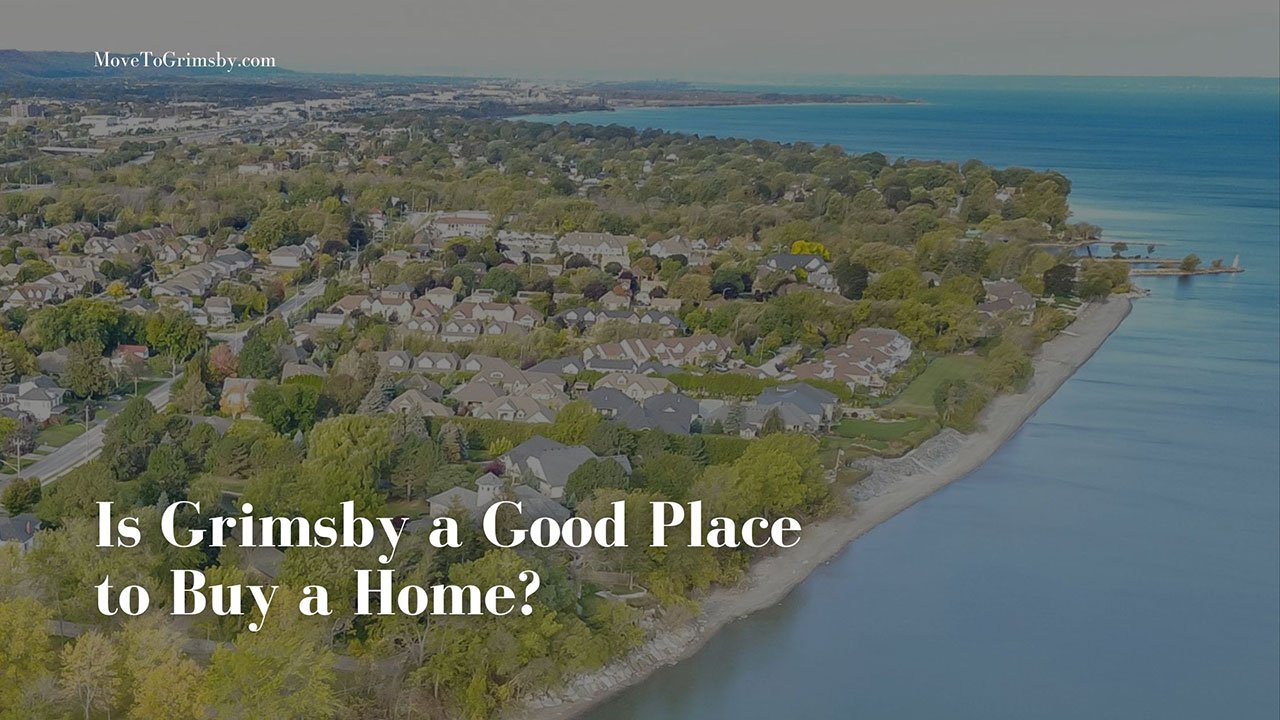 Aerial view of a tree-lined Grimsby neighbourhood meeting the sandy Lake Ontario shoreline.